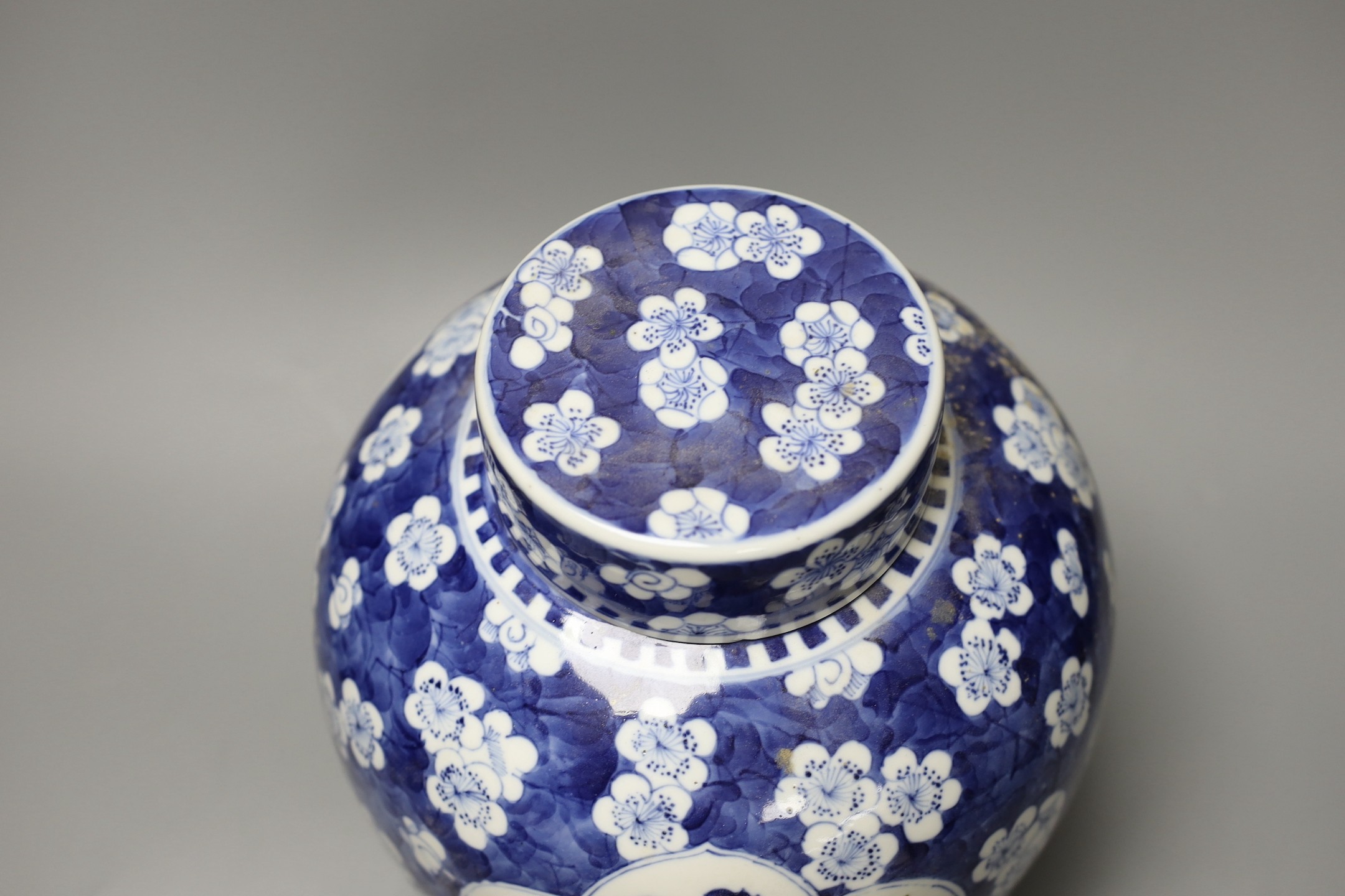 A large 19th century Chinese blue and white prunus jar and cover, 25cm